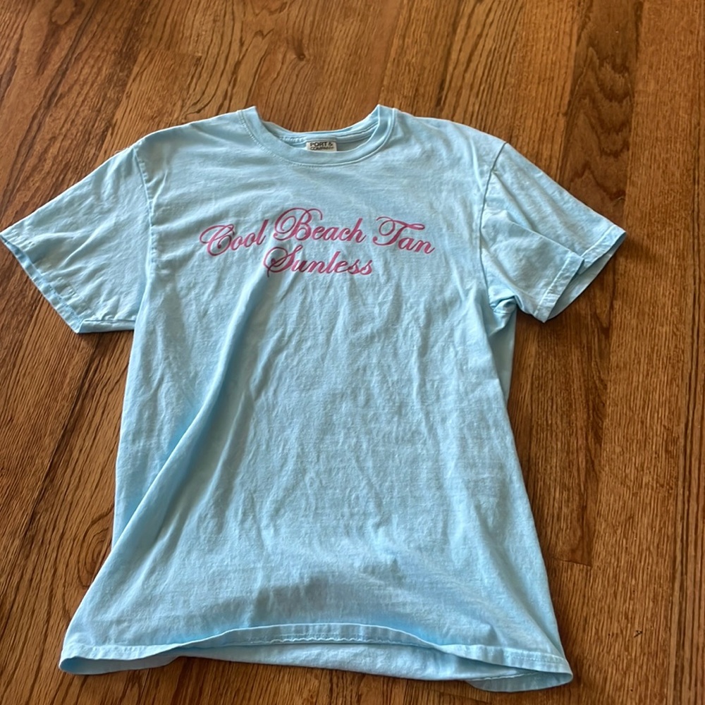 Brand is Port & Company. Size is medium. Color is light blue with pink writing!